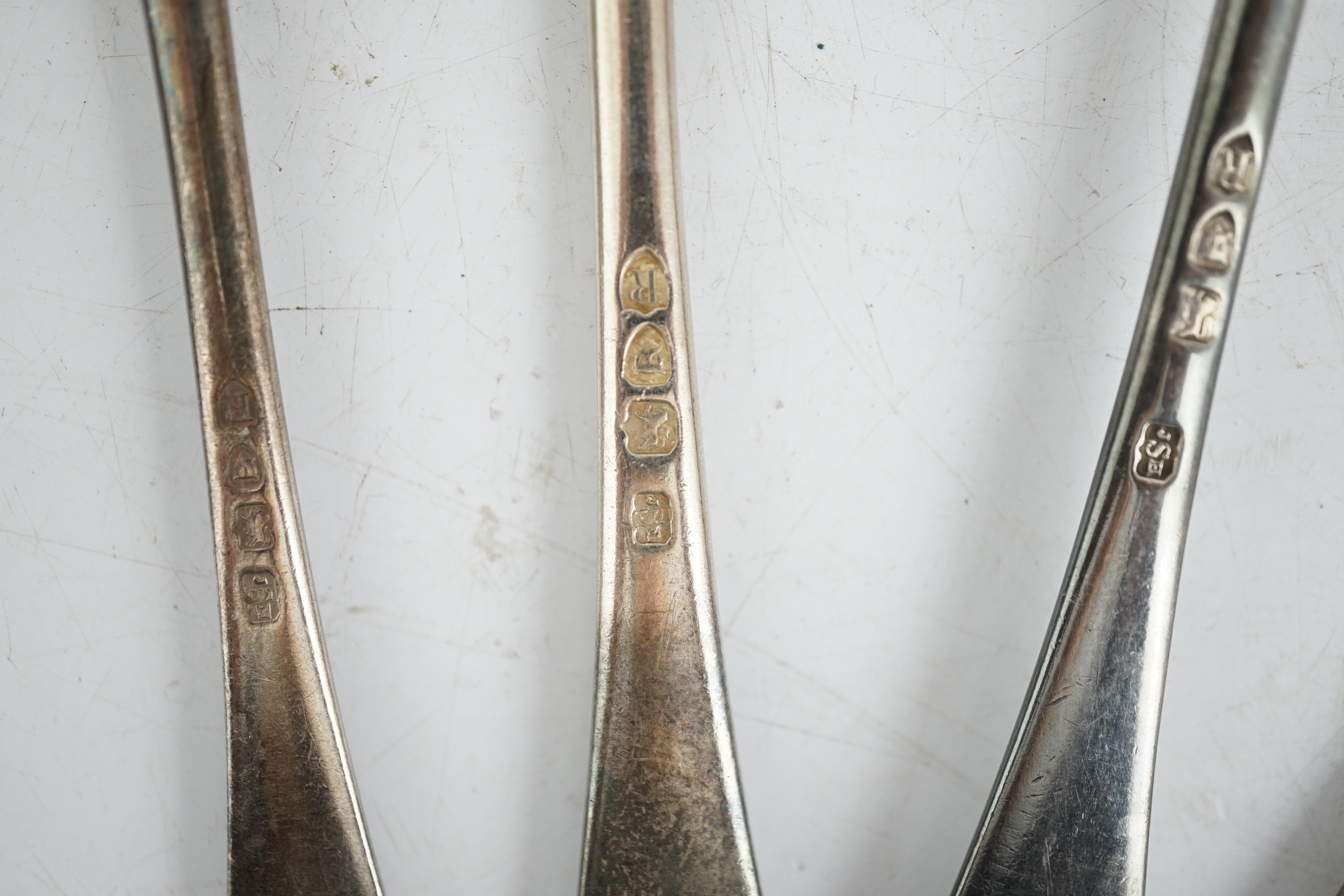 Sundry silver, consisting of three pieces of George III flatware, two 800 standard coffee spoons, a pair of candlesticks(a.f.), a lidded glass preserve pot, clothes brush, two pepperettes and a desk seal.